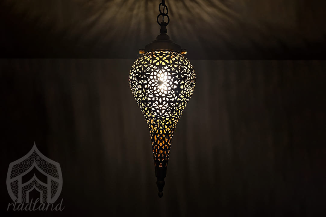 Small-golden-hanging-lamp-in-the-dark-ideal-for-adding-a-luxurious-touch-to-compact spaces-like-a-hallway-or-toilet