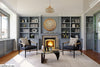 Elegant-relaxation-room-with-a-fireplace-bookshelves-and-a-stylish-hanging-lamp