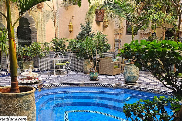  A fairytale riad courtyard with terrace and a pool, adorned with zellige tiles, handmade lamps and exotic plants