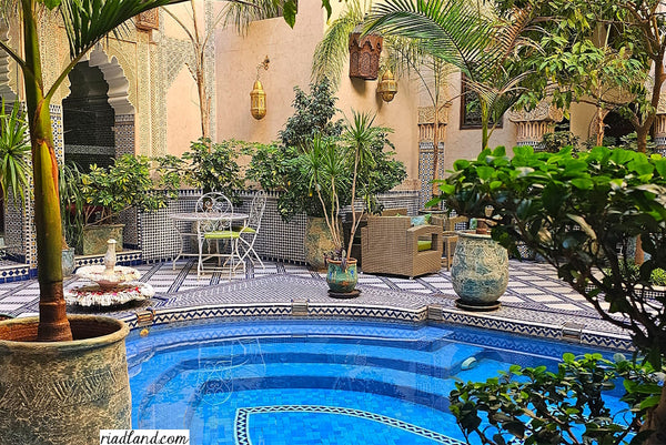  A fairytale riad courtyard with terrace and a pool, adorned with zellige tiles, handmade lamps and exotic plants