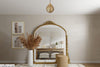 A-large-golden-mirror-with-an-exclusive-golden-hanging-lamp-above