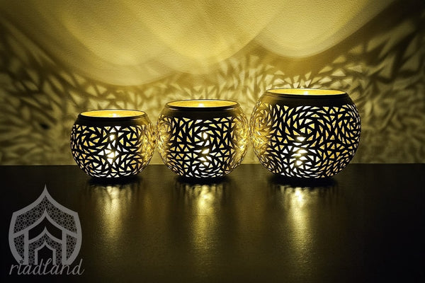 Brass candle pots that emit a warm glow, casting beautiful patterns that create a cozy and inviting ambiance in the room