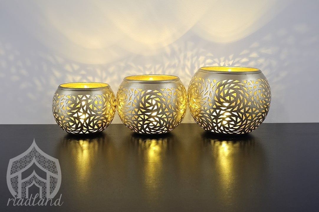 A trio of rounded golden candle pots crafted from brass, giving your space a warm and cozy ambiance