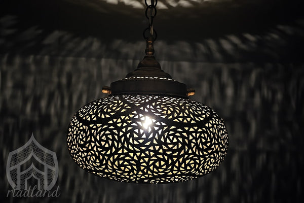 Luxury golden brass lamp in the dark with cozy patterns on the wall