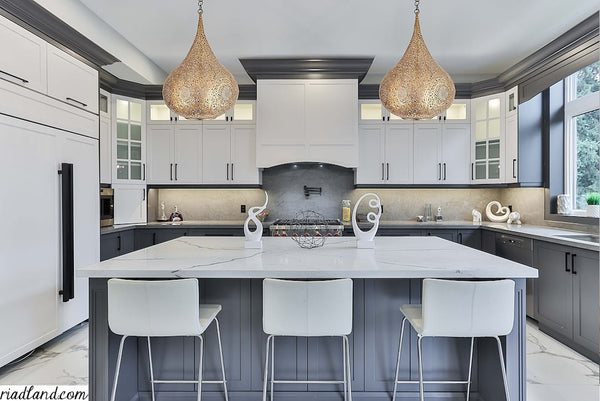 Chic-modern-kitchen-with-white-cabinets-a-marble-island-and-two-large-handmade-pendant-lamps