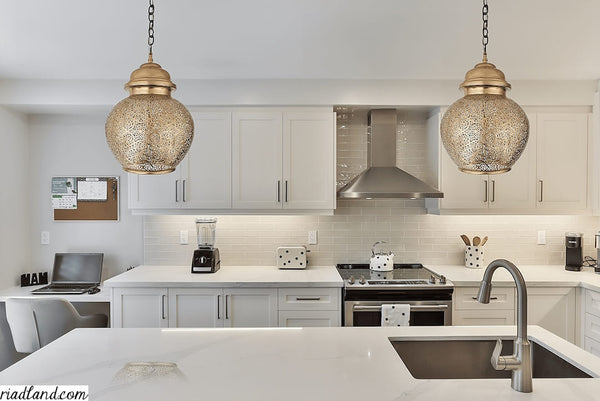 Luxurious-kitchen-with-white-cabinets-a-sink-and-two-large-pendant-lamps-above-the-central-kitchen-island