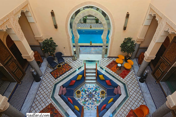 Luxurious Riad lounge area with pool view from above showcasing traditional tilework