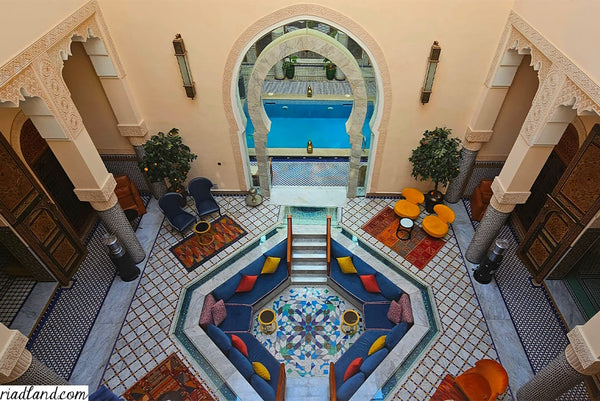 Luxurious Riad lounge area with pool view from above showcasing traditional tilework