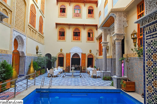 Beautiful Riad courtyard with swimming pool and a fountain in the middle of the terrace