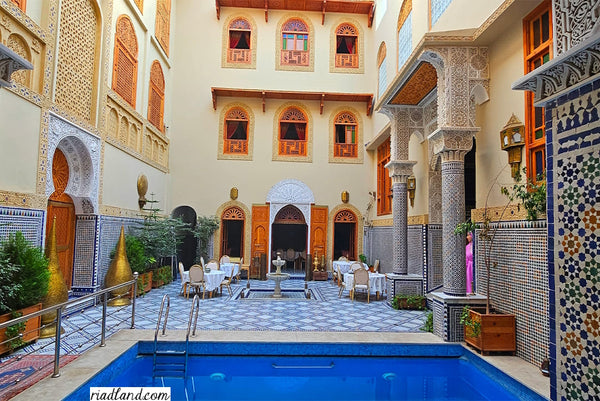 Beautiful Riad courtyard with swimming pool and a fountain in the middle of the terrace